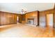 Bright living room featuring hardwood floors, wood paneling, and a fireplace at 406 Forest Dr, York, SC 29745