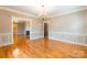 Elegant living room boasts hardwood floors, decorative molding, and a view to a fireplace at 406 Forest Dr, York, SC 29745