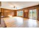 Spacious living room features wood paneling, a fireplace, and access to the backyard at 406 Forest Dr, York, SC 29745