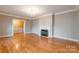 Bright living room boasts hardwood floors, a fireplace, crown moulding, and neutral walls at 406 Forest Dr, York, SC 29745