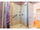 Shower with glass door and shelving featuring accessibility grab bar at 406 Forest Dr, York, SC 29745