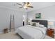 Bedroom featuring a ceiling fan, carpet, a gray cushioned headboard and modern decor at 5601 Fairview Rd # 24, Charlotte, NC 28209