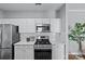 Well-lit kitchen with stainless steel appliances, white cabinets, and marble countertops at 5601 Fairview Rd # 24, Charlotte, NC 28209