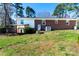 Spacious backyard features a small stone firepit and a covered walkout basement entrance at 601 Carole Ln, Charlotte, NC 28214