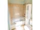 Tiled shower and tub combo with shelving in the remodeled bathroom at 601 Carole Ln, Charlotte, NC 28214