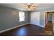 Bedroom boasts a ceiling fan, closet, and hardwood flooring at 601 Carole Ln, Charlotte, NC 28214