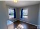 Bedroom with wood-look flooring and two windows offering natural light at 601 Carole Ln, Charlotte, NC 28214