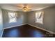 A bedroom featuring a ceiling fan and two windows with white trim at 601 Carole Ln, Charlotte, NC 28214