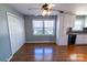 Open-concept kitchen with white cabinets, stainless steel appliances, and hardwood floors at 601 Carole Ln, Charlotte, NC 28214