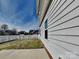 Side view of a home with a concrete patio and a fenced backyard on a sunny day at 620 Weyburn Nw Dr, Concord, NC 28027