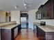 Stylish kitchen showcases dark cabinetry, granite countertops, and stainless steel appliances at 620 Weyburn Nw Dr, Concord, NC 28027