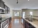 Modern kitchen with granite countertops, stainless appliances, and dark cabinets at 620 Weyburn Nw Dr, Concord, NC 28027