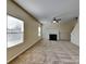 Cozy living room features a fireplace, neutral carpet, and ample natural light at 620 Weyburn Nw Dr, Concord, NC 28027