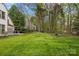 Expansive backyard with a green lawn and a cozy fire pit area at 6319 High Creek Ct, Charlotte, NC 28277
