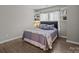 Well-lit bedroom featuring neutral walls, wood floors, and built-in shelves at 6319 High Creek Ct, Charlotte, NC 28277
