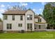 Rear exterior view of the home showcasing the deck and well-maintained yard at 6319 High Creek Ct, Charlotte, NC 28277