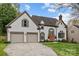 Charming two-story home with a well-manicured lawn, two-car garage, and inviting orange front door at 6319 High Creek Ct, Charlotte, NC 28277