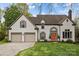 Charming two-story home with a well-manicured lawn, two-car garage, and inviting orange front door at 6319 High Creek Ct, Charlotte, NC 28277