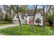 Charming home featuring a well-manicured lawn, a two-car garage, and a vibrant orange front door at 6319 High Creek Ct, Charlotte, NC 28277