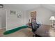 Bright home office space offers a desk, putting green, and ample natural light at 6319 High Creek Ct, Charlotte, NC 28277