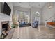 Spacious living room with a fireplace, large windows, and comfortable seating at 6319 High Creek Ct, Charlotte, NC 28277