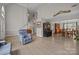 Open-concept living area with tall ceilings, a staircase, wood-look flooring, and dining area at 6319 High Creek Ct, Charlotte, NC 28277