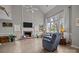 Bright living room featuring a fireplace, tall windows, and comfortable seating at 6319 High Creek Ct, Charlotte, NC 28277