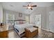 Bright main bedroom boasts vaulted ceilings, a ceiling fan, and an ensuite bathroom view at 6319 High Creek Ct, Charlotte, NC 28277