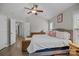 Spacious main bedroom features a large bed, wood floors, and natural light from multiple windows at 6319 High Creek Ct, Charlotte, NC 28277
