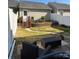 Backyard patio featuring black wicker seating, and a walkway leading to a raised landscape bed under a shed at 6410 Hasley Woods Dr, Huntersville, NC 28078