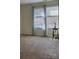 Bedroom featuring carpeted floors, neutral walls, and a window with curtains and blinds, providing natural light at 6410 Hasley Woods Dr, Huntersville, NC 28078