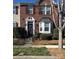 Charming brick townhome featuring a classic design, bay window, and inviting entrance at 6410 Hasley Woods Dr, Huntersville, NC 28078