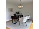 Bright home office featuring modern desk and chairs, chandelier lighting and neutral area rug at 6410 Hasley Woods Dr, Huntersville, NC 28078
