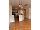 Open-concept living area with hardwood floors, modern lighting, and a seamless flow to the kitchen at 6410 Hasley Woods Dr, Huntersville, NC 28078