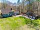 Aerial view of house with large, green back yard, outbuildings, and proximity to mature trees at 6688 Pine Forest Dr, York, SC 29745