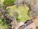 Aerial view showcasing the house, surrounding trees, a well-manicured lawn, and natural landscape at 6688 Pine Forest Dr, York, SC 29745