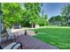 Backyard featuring a wooden deck, two sheds, and a large lawn at 6688 Pine Forest Dr, York, SC 29745