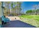 Spacious backyard with a deck, gravel area, green grass, and sheds at 6688 Pine Forest Dr, York, SC 29745