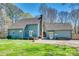 Spacious backyard with green lawn, deck, patio area with seating, and mature trees surrounding the property at 6688 Pine Forest Dr, York, SC 29745
