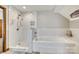 Bright renovated bathroom featuring a shower, a bathtub, and marble-style tile surround at 6688 Pine Forest Dr, York, SC 29745