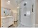 Well-lit bathroom featuring a glass shower, a vanity, and decorative tile at 6688 Pine Forest Dr, York, SC 29745