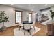 Well-lit dining space features a round table, wood-framed windows, and hardwood floors at 6688 Pine Forest Dr, York, SC 29745