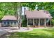 Charming home with a welcoming front porch, a well-maintained lawn, and a detached garage at 6688 Pine Forest Dr, York, SC 29745