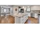 Open kitchen view showcasing a kitchen island, stainless steel appliances, and hardwood floors at 6688 Pine Forest Dr, York, SC 29745