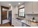 Kitchen with white cabinetry, stone countertops, subway tile backsplash, and a stainless steel dishwasher at 6688 Pine Forest Dr, York, SC 29745