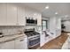 Bright kitchen features white cabinets, stainless steel appliances, granite countertops, and a cozy window seat at 6688 Pine Forest Dr, York, SC 29745