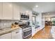 Modern kitchen with stainless steel appliances, white cabinets, granite counters, and hardwood floors at 6688 Pine Forest Dr, York, SC 29745