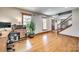 Bright living room features hardwood floors and large windows, creating a warm and inviting atmosphere at 6688 Pine Forest Dr, York, SC 29745