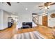 Spacious living room with hardwood floors, ceiling fan, brick fireplace and open concept layout at 6688 Pine Forest Dr, York, SC 29745