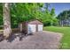 Exterior of metal outbuilding, featuring dual roll-up garage doors and gravel drive at 6688 Pine Forest Dr, York, SC 29745